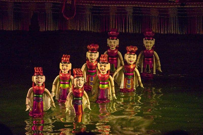 going to a water puppet show while visiting hanoi