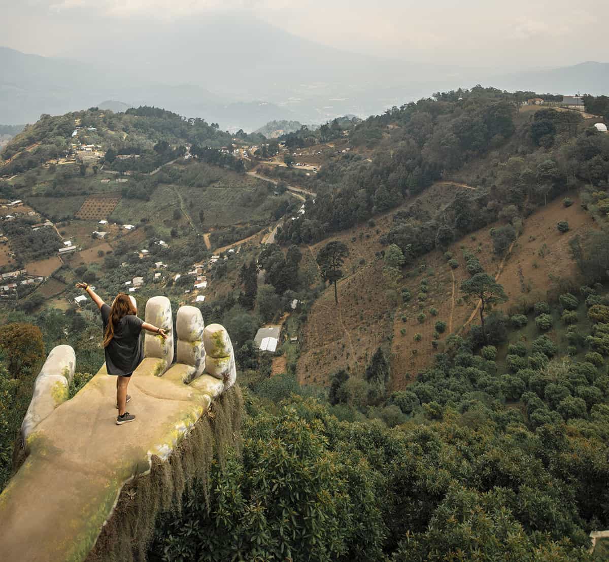 taking that famous photo from the hand, one of the more popular attractions at hobbitenango