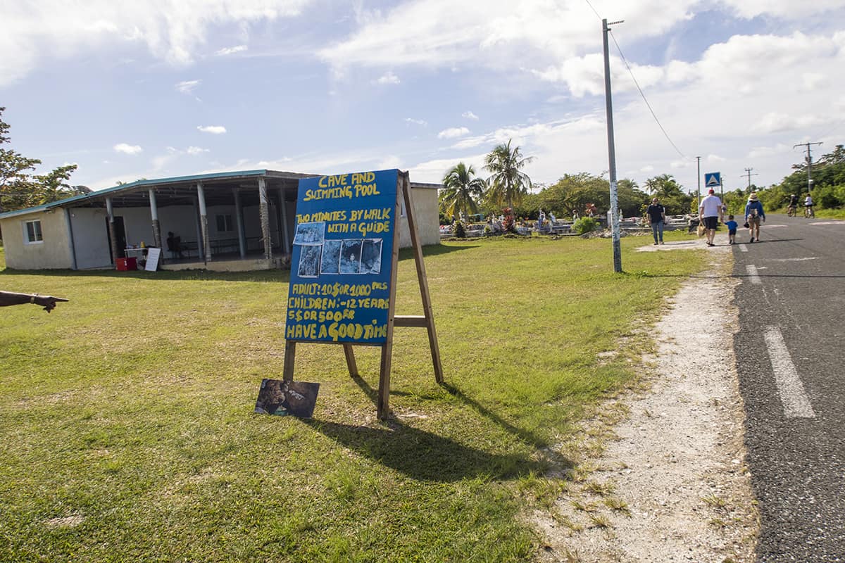 signage on the main road pointing to the cave and swimming pool at the secret grotto in lifou