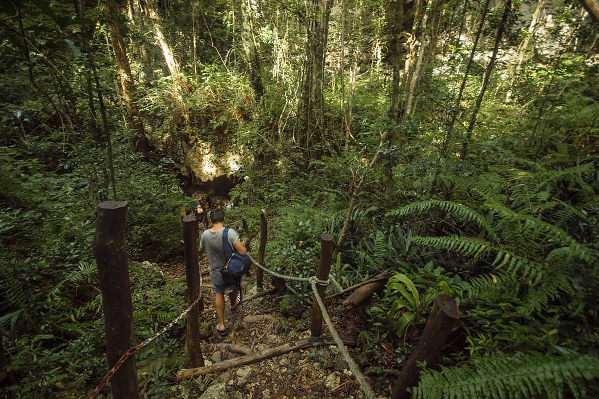 hiking down the stairs to the entry of the cave