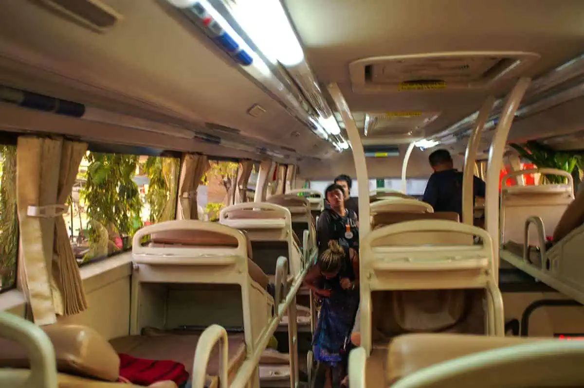 Passengers enjoy their ride on a Vietnam Sleeper Bus, relaxing on reclining seats in a shared, yet comfortable, travel space.