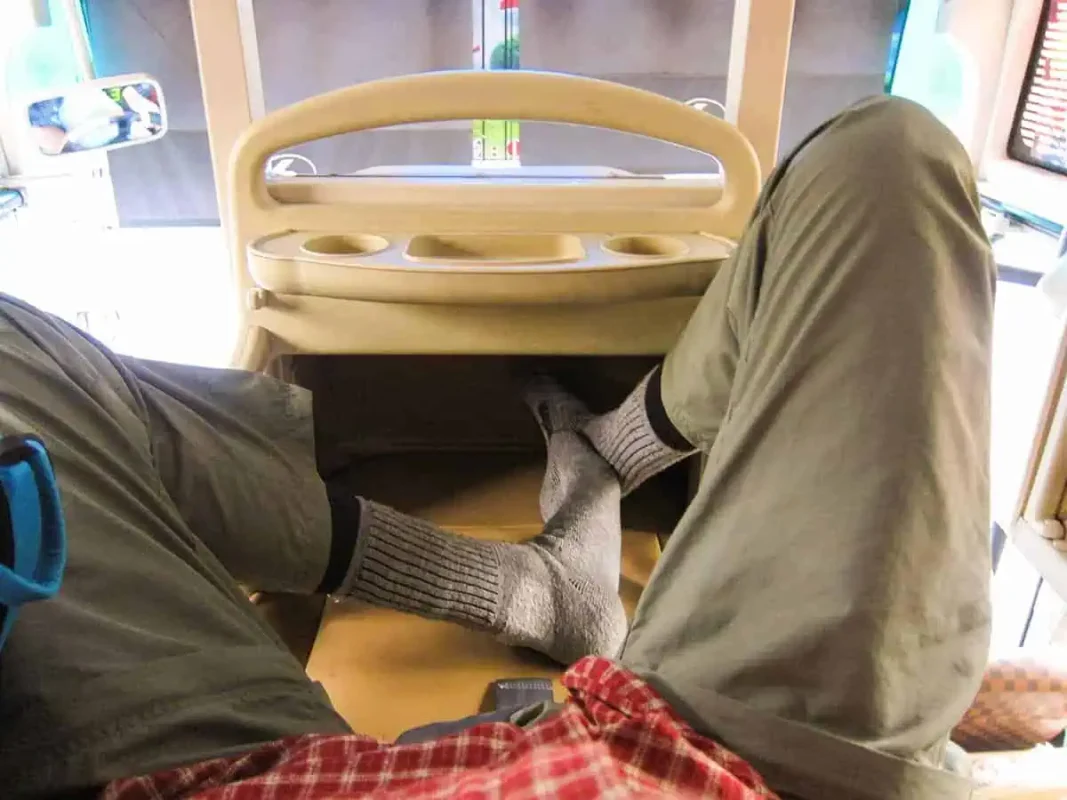 First-person view inside a VIP sleeper bus in Vietnam, demonstrating the legroom and seating arrangement for an overnight journey.