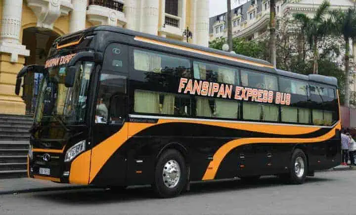 A 'Fansipan Express' VIP sleeper bus parked in Vietnam, representing the upscale option for intercity travel on Vietnamese sleeper buses.