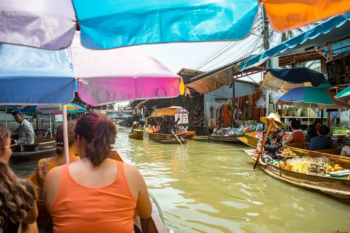 floating through the famous damnoen saduak market with boats nearby selling food