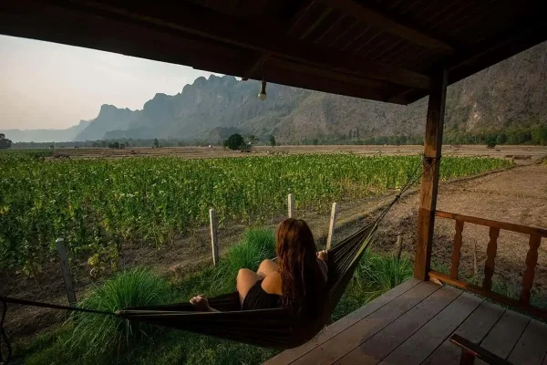 tasha amy sitting on hammock in kong lor 2 weeks in laos itinerary