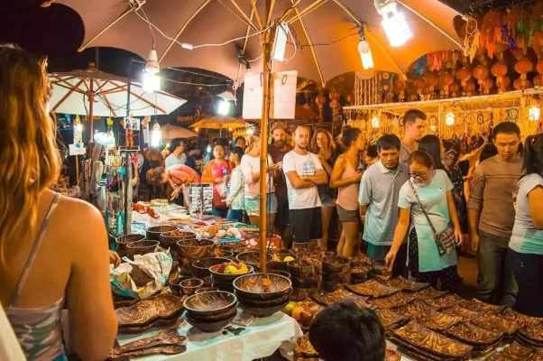 Crowded evening scene capturing the lively atmosphere of the Chiang Mai Sunday Night Market with visitors and local shops.