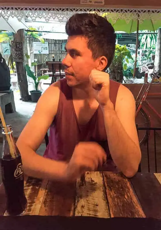 Chiang Mai To Luang Prabang: Slow Boat, Bus Or Flight? 35 a man at a local restaurant in chiang khong