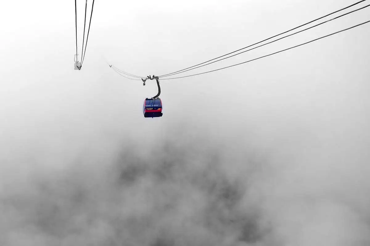 3 Days In Sapa Itinerary: Trekking, Fansipan & Homestay 47 A car rides through clouds heading toward Fansipan Peak in Sapa.
