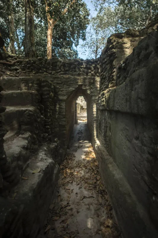 Cahal Pech Mayan Ruins In San Ignacio: A Hidden Gem Away from the Crowds 55 looking through one of the doorways and step staircases at cahal pech mayan ruins