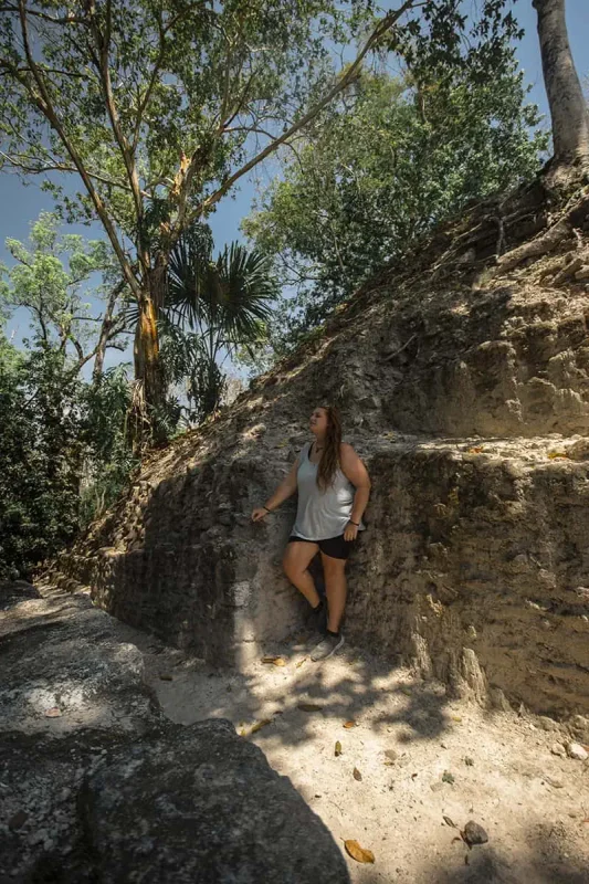 Cahal Pech Mayan Ruins In San Ignacio: A Hidden Gem Away from the Crowds 68 tasha amy finding a little bit of shade while exploring one of the temples at cahal pech mayan ruins