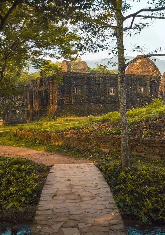 My Son Sanctuary Hoi An: BEST Tips & Tours (2026) 46 looking over at one of the temples at my son sanctuary over a stone bridge with a stream running underneath