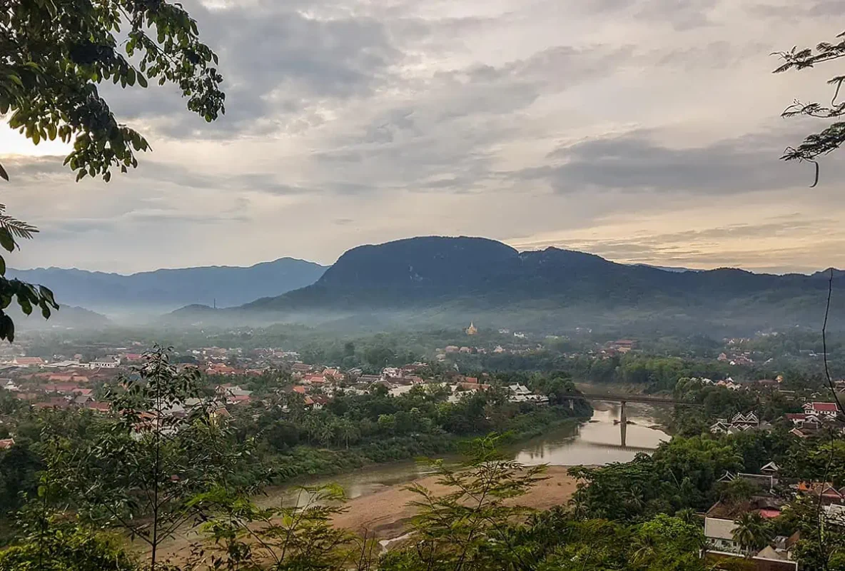 looking over the town of luang prabang from mount phousi on a cloudy morning
