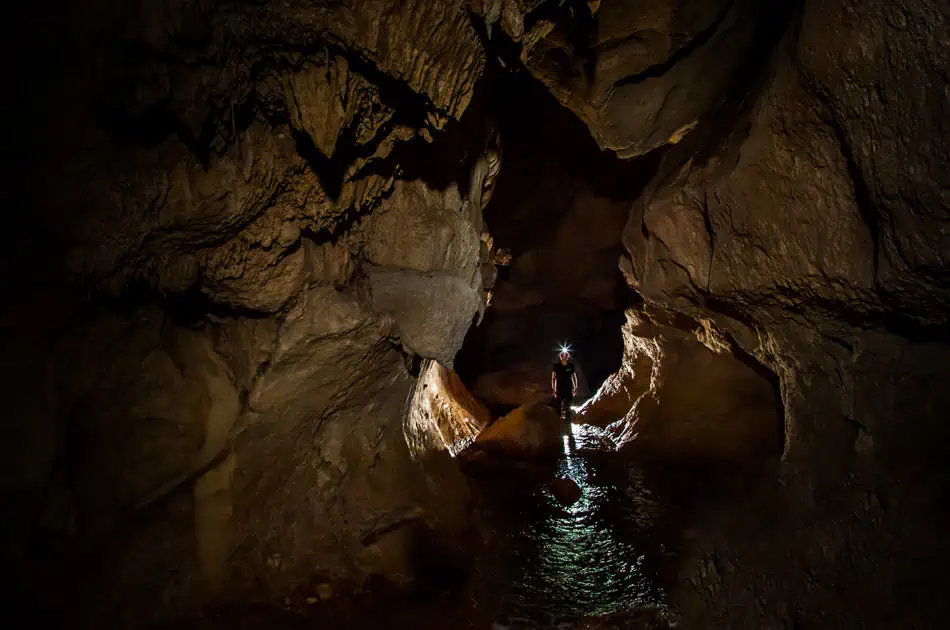 ATM Cave Tour From San Ignacio: Is It REALLY Worth The Price? 59 a lone traveler looking out into the atm cave with a head torch on