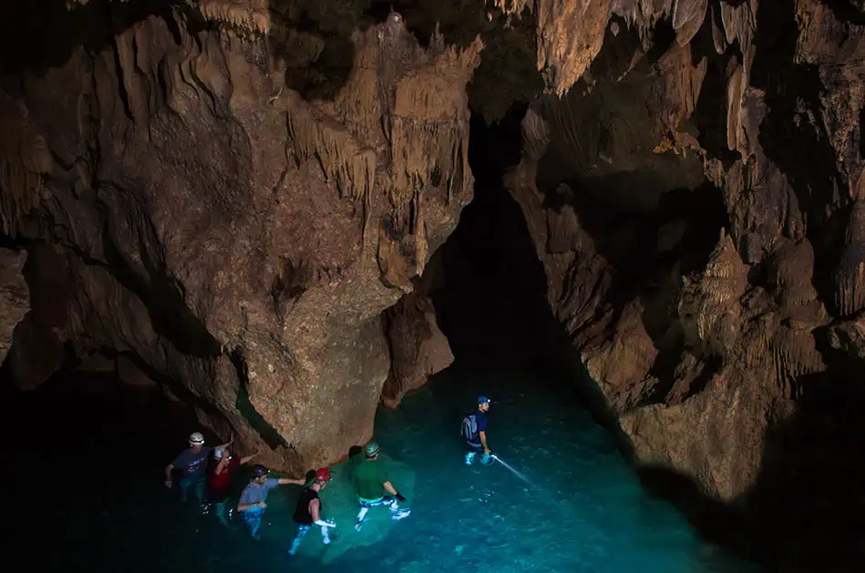 ATM Cave Tour From San Ignacio: Is It REALLY Worth The Price? 63 hiking through a deeper section of water on the atm cave tour, using torches to see the way