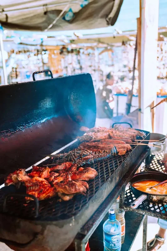 Backpacking Belize: The BEST Guide For Travelers 2026 73 fresh seafood being cooked on a bbq at the beach in caye caulker