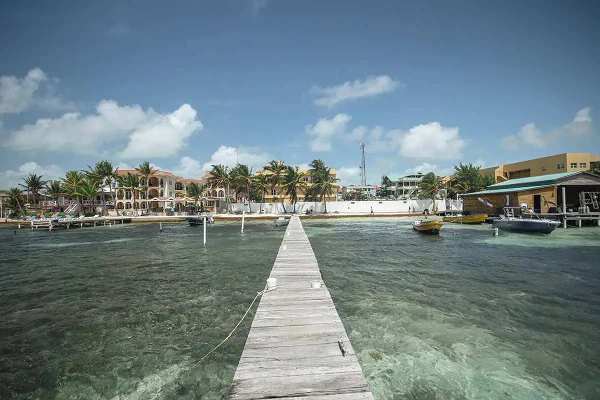 Backpacking Belize: The BEST Guide For Travelers 2026 58 standing on the end of a pier at san pedro looking back towards ambergris caye