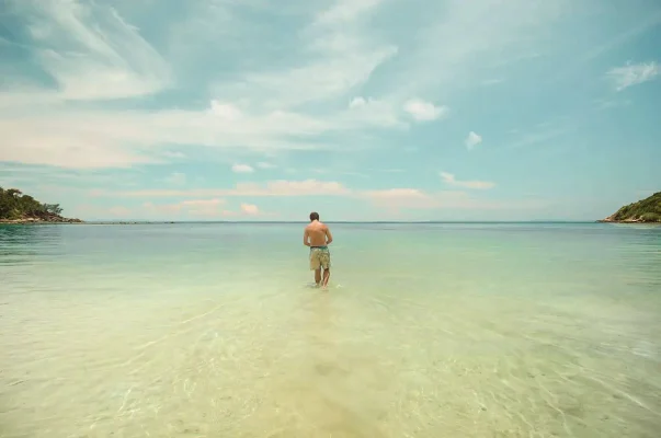 walking out into the water at haad salad , one of the best beaches in koh phangan