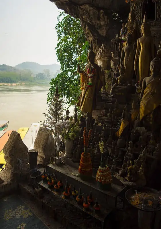 decorative buddhas in pak ou caves looking out to the mekong river