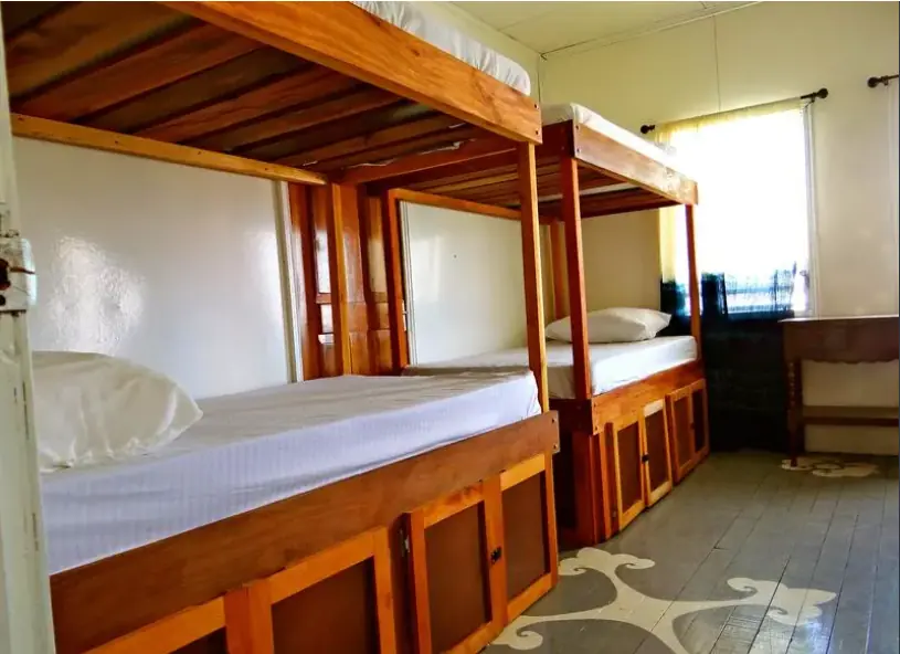 Best Hostels In San Ignacio: 5 Excellent Stays For Travelers On A Budget 54 Sturdy and inviting wooden bunk beds in a bright room at Old House Hostel, a contender for the best San Ignacio hostel.