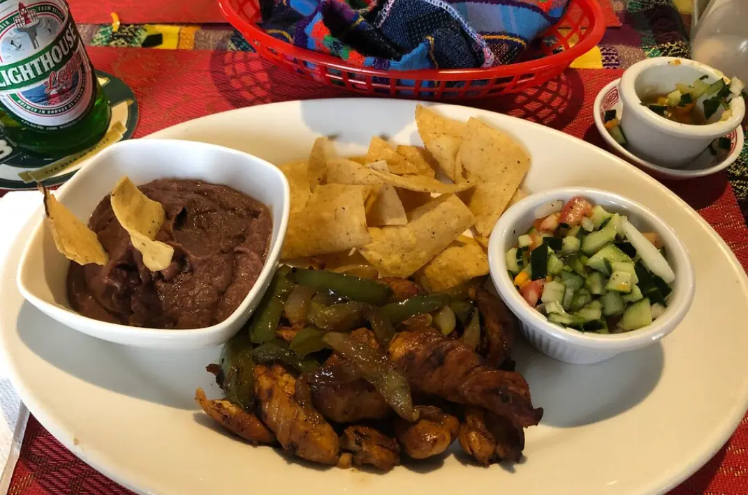 12 Best Restaurants In San Ignacio: Top Eats For Visitors 58 A hearty Belizean meal with rice and beans, stewed chicken, coleslaw, and fried plantains, served at Cenaida’s Belizean Food, one of the best restaurants in San Ignacio.