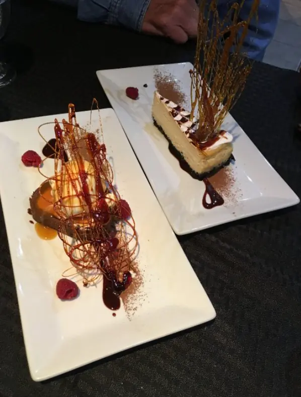 12 Best Restaurants In San Ignacio: Top Eats For Visitors 64 An elegant dessert presentation featuring a slice of cheesecake with a caramel spiral decoration, showcasing the culinary creativity found in San Ignacio, from crave house of flavors