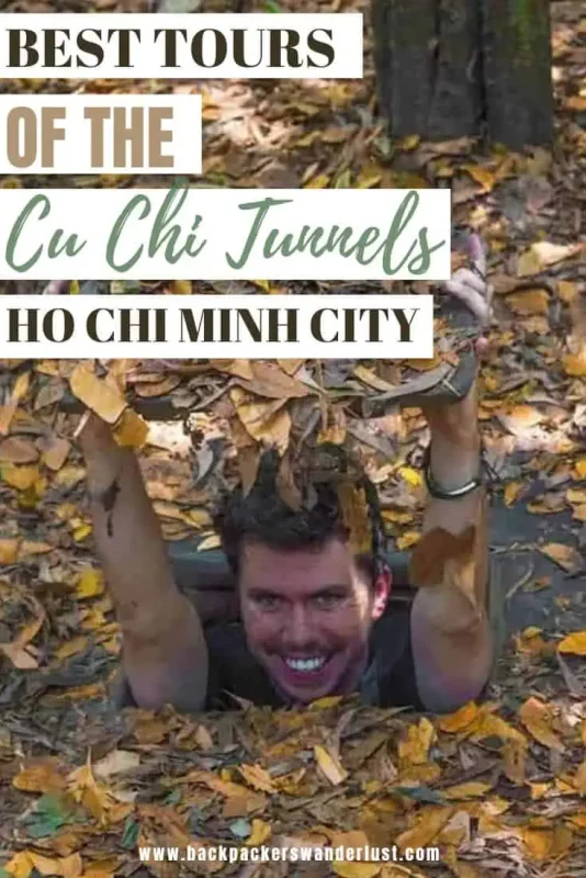 Best Cu Chi Tunnels Tours: Cheap VS Expensive 2026 59 Promotional image for tours of the Cu Chi Tunnels in Ho Chi Minh City, featuring a man emerging from a tunnel opening covered with fallen leaves, smiling excitedly towards the camera. Text overlay reads 'Best Tours of the Cu Chi Tunnels Ho Chi Minh City' with the website address 'www.backpackerswanderlust.com' at the bottom.