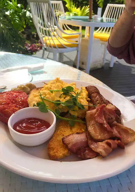 Where To Eat In Rarotonga: BEST Restaurants & Cafes 2026 27 Hearty breakfast plate with scrambled eggs and bacon, served at the lazy trout, perfect for starting a day of island exploration.