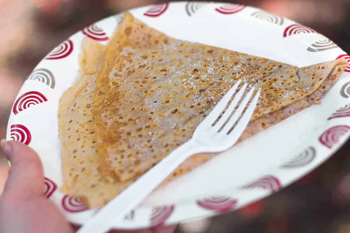 Where To Eat In Rarotonga: BEST Restaurants & Cafes 2026 22 A golden brown crepe sprinkled with sugar, a simple yet delightful dessert found at the Punanga Nui Market, a popular breakfast spot in Rarotonga