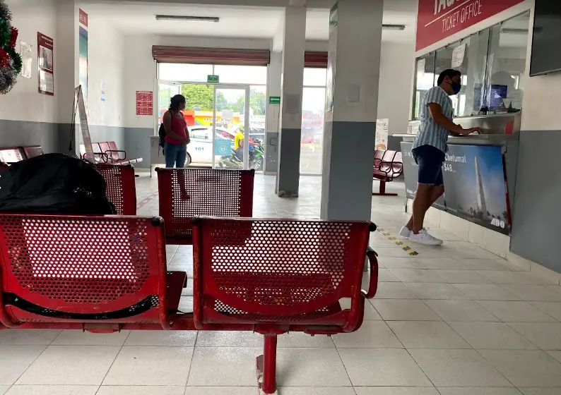 Bacalar To Caye Caulker: The ULTIMATE Travel Guide 2026 58 An image of the bus waiting area in bacalar with chairs arranged in rows.