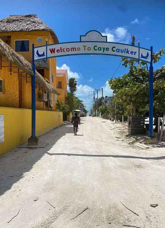 Chetumal To Caye Caulker: Best & Easiest Transport 2026 60 A "Welcome to Caye Caulker" sign over a sandy street. This sign greets travelers arriving from Chetumal to Caye Caulker.