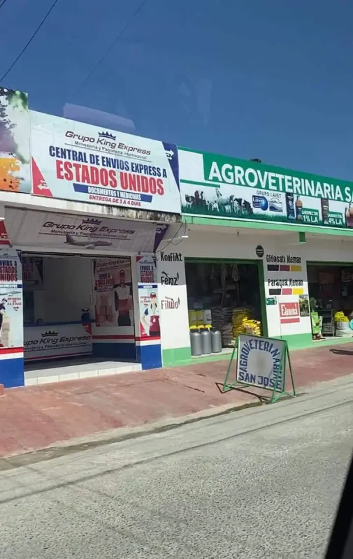 Travel San Ignacio To Flores & Crossing The Border 27 The storefront of Grupo King Express features a sign advertising 'Central de Envios Express a Estados Unidos,'at a town on the way to flores.