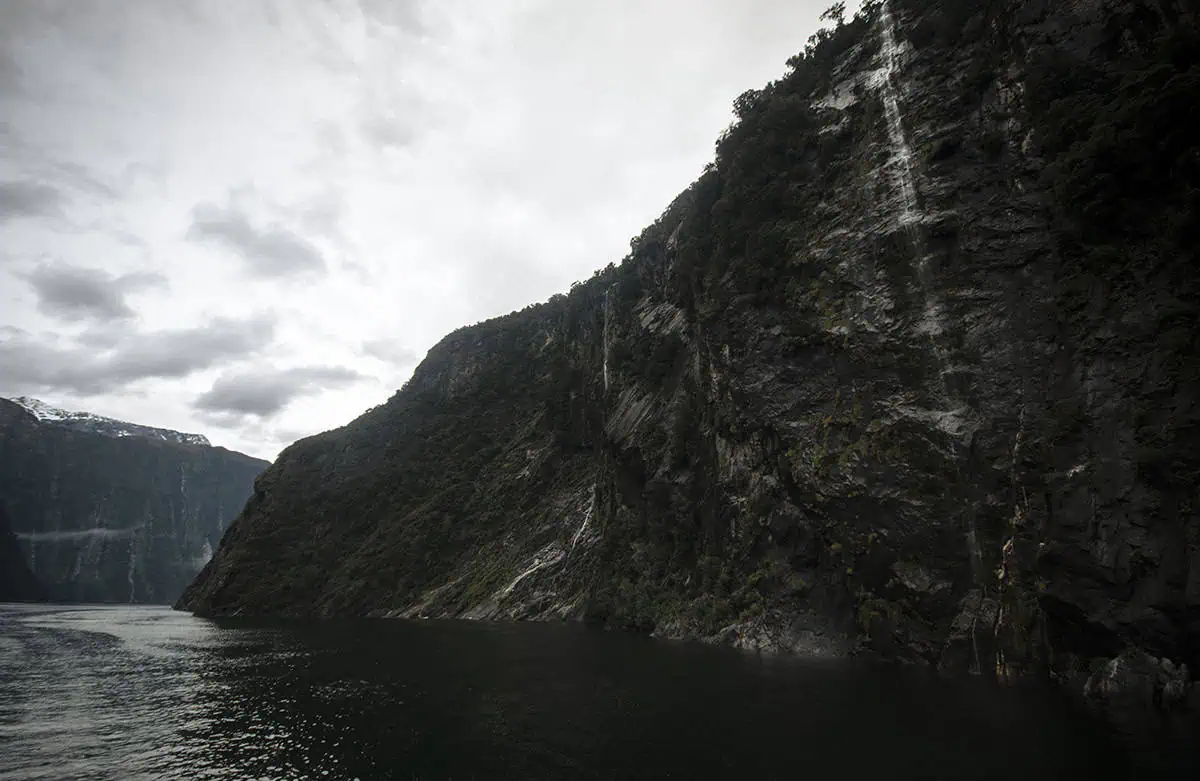 Best Waterfalls In Milford Sound Worth Checking Out 6 A part of the four sisters waterfall cascades down a steep cliffside into the still water, one of the best waterfalls in milford sound