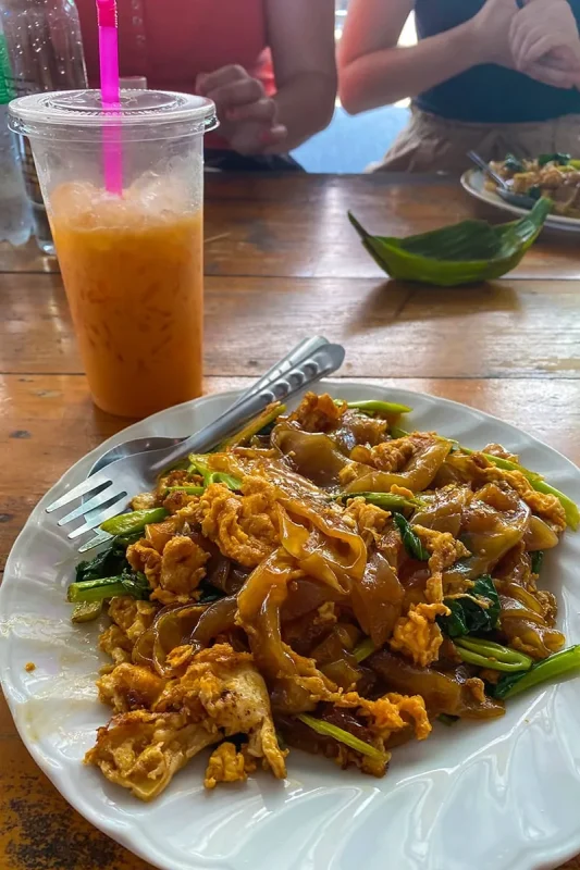 2 Days in Bangkok Itinerary For First-Time Visitors 46 lunch consisting of pad see ew and a Thai iced tea in Bangkok