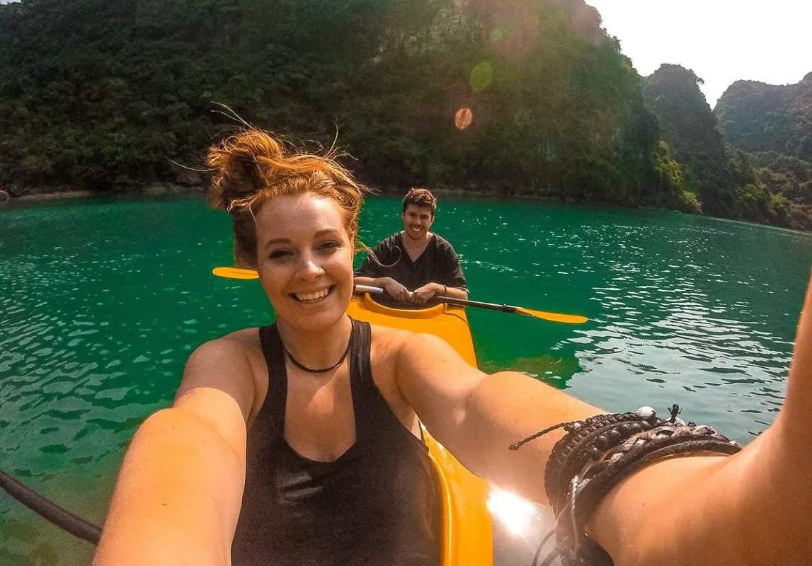 3 Weeks In Vietnam Itinerary: The Perfect First-Time Route 60 Tasha Amy in a yellow kayak exploring the waters in Lan Ha Bay in Vietnam