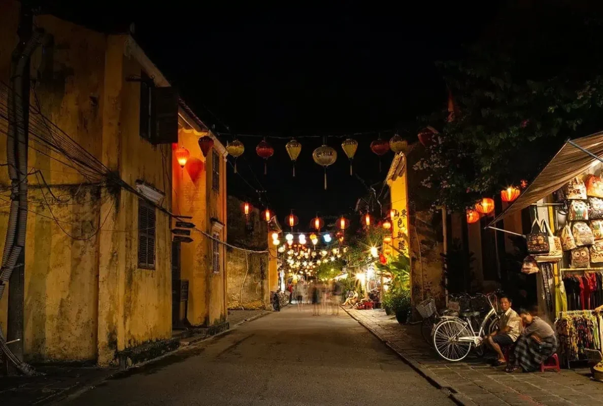 3 Weeks In Vietnam Itinerary: The Perfect First-Time Route 74 Night view down a road in Hoi An Ancient Town with lanterns lighting the way