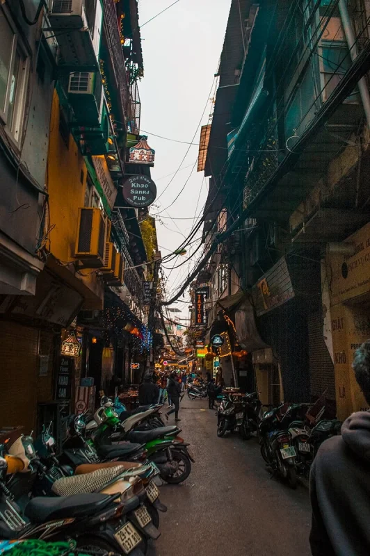 3 Weeks In Vietnam Itinerary: The Perfect First-Time Route 47 Narrow lane with many motorbikes parked up in Hanoi's Old Quarter