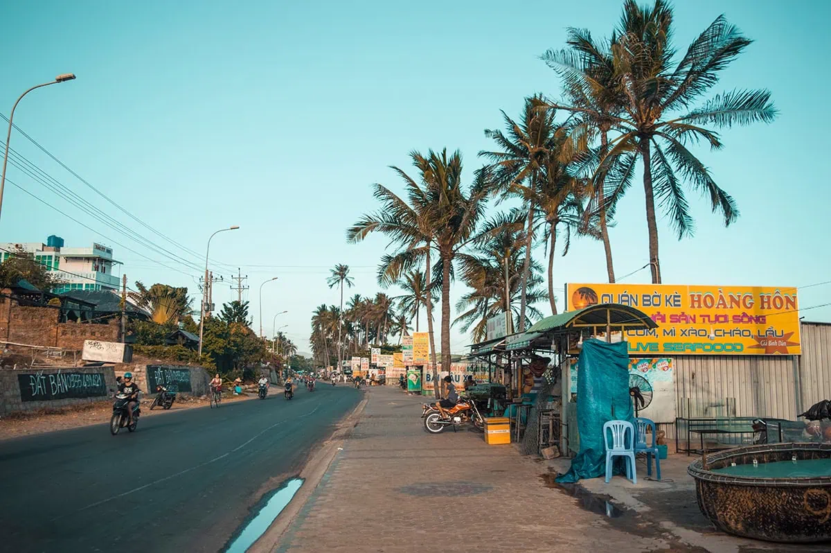 3 Weeks In Vietnam Itinerary: The Perfect First-Time Route 85 Along the main street in Mui Ne with local businesses and palm trees.