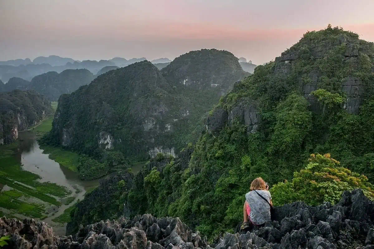 A women at a viewpoint overlooking a river valley in Ninh Binh on the 3 weeks in Vietnam itinerary