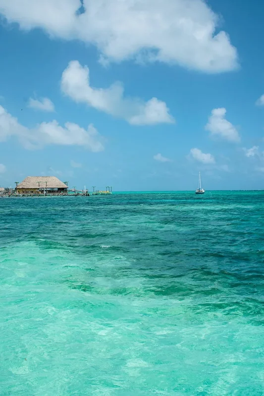 Best Beaches In Ambergris Caye For Swimming & Snorkeling 68 Looking out over the blue water in Ambergris Caye over towards the Palapa Bar and Grill.