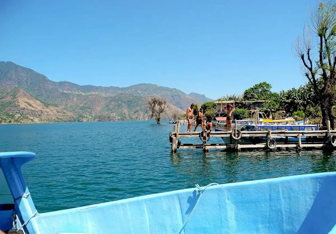 tourists jumping off one of the piers around Lake Atitlan in the questionable waters