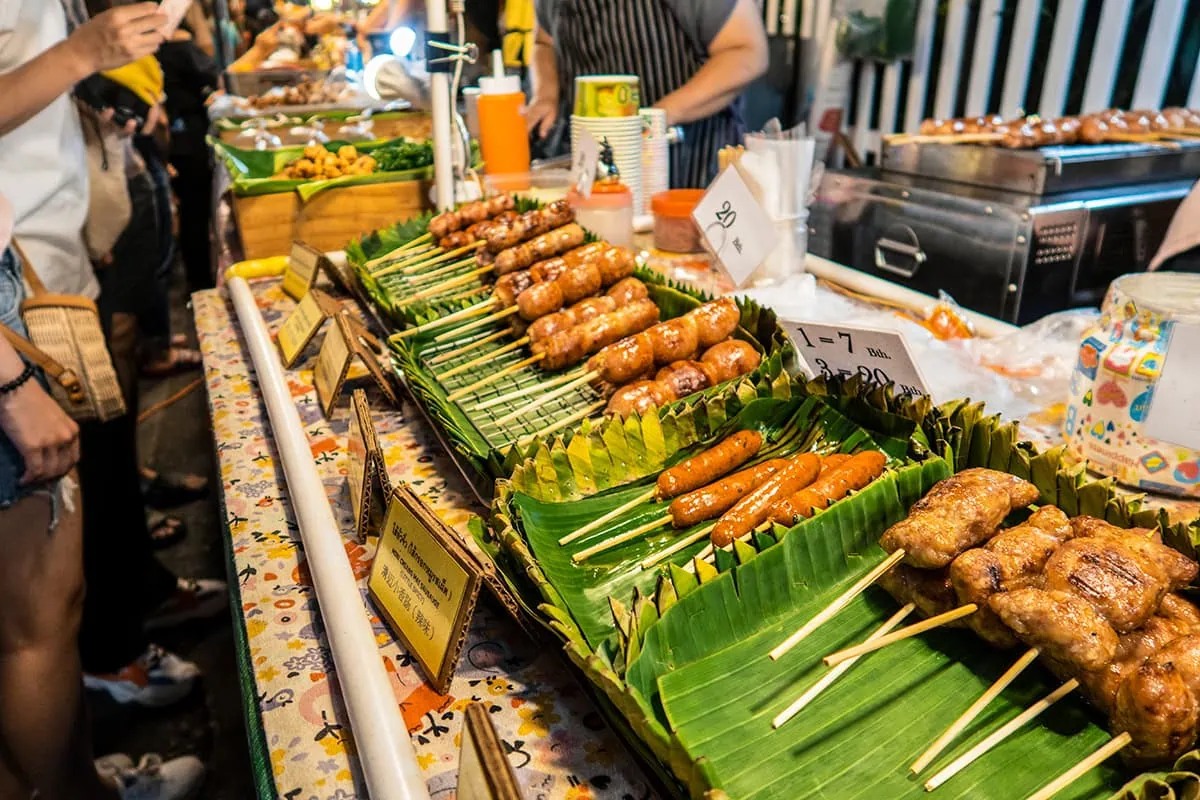 A variety of grilled sausages on banana leaves at the Chiang Mai Sunday market