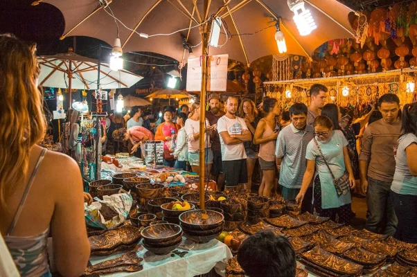 Crowded evening with people lined up around a table at the Chiang Mai Sunday Night Market