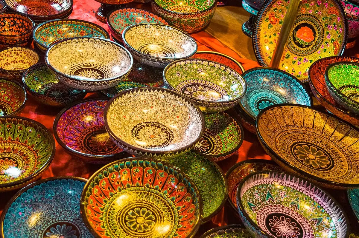 brightly colored bowls with intricate designs on display at the Sunday Walking Street in Chiang Mai