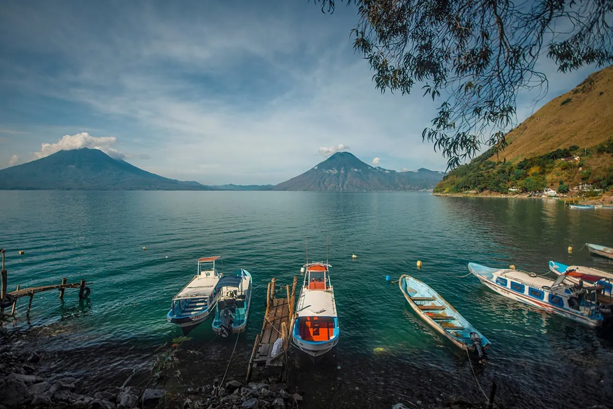 How To Get Around Lake Atitlan: Lanchas, Prices & Tips 25 boats on the shoreline from Santa Cruz in Lake Atitlan