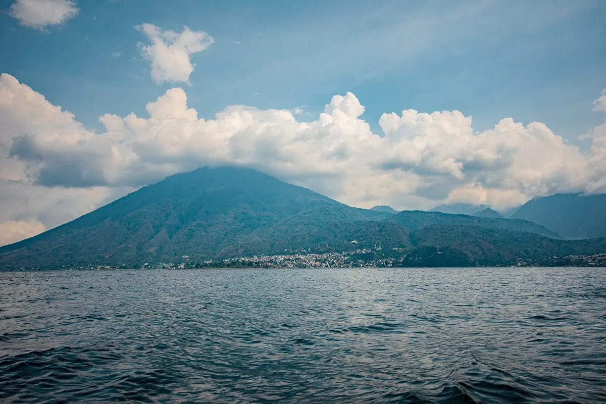 How To Get Around Lake Atitlan: Lanchas, Prices & Tips 28 Looking over to the volcano while taking a boat around Lake Atitlan