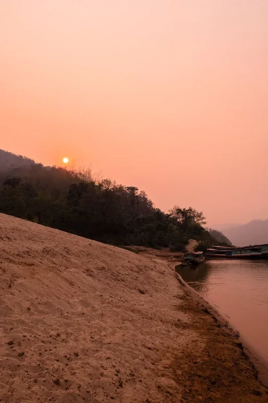 Slow Boat Laos: My Honest Guide After Doing It Twice (2026) 44 Red sunset at the banks of the Mekong River