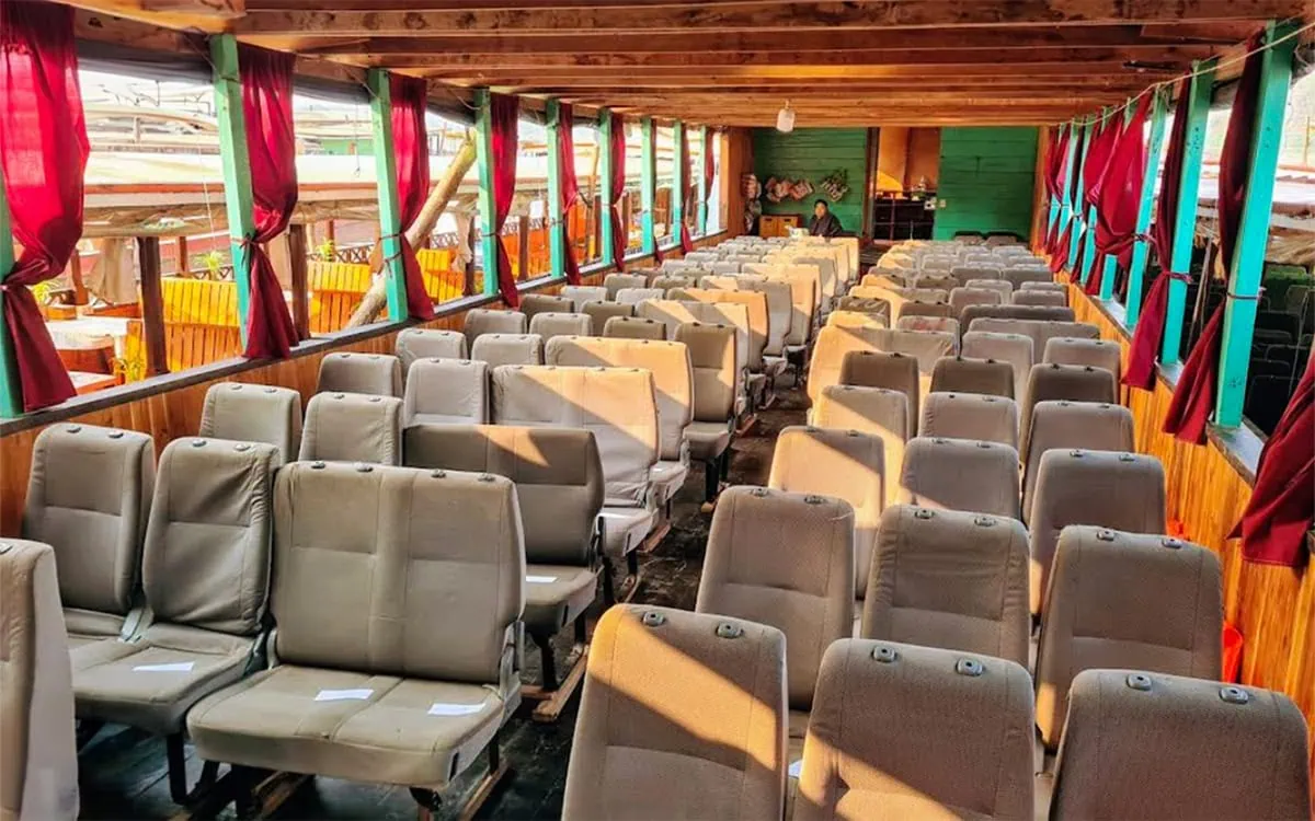 Slow Boat Laos: My Honest Guide After Doing It Twice (2026) 54 An empty slow boat to Laos with all of the old van seats lined up in Huay Xai