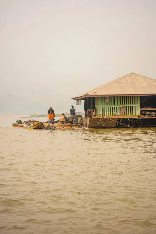 Slow Boat Laos: My Honest Guide After Doing It Twice (2026) 41 A floating market on the Mekong River with locals on boats