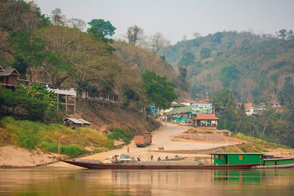 Slow Boat Laos: My Honest Guide After Doing It Twice (2026) 47 A boat parked up in Pakbeng in Laos unloading goods