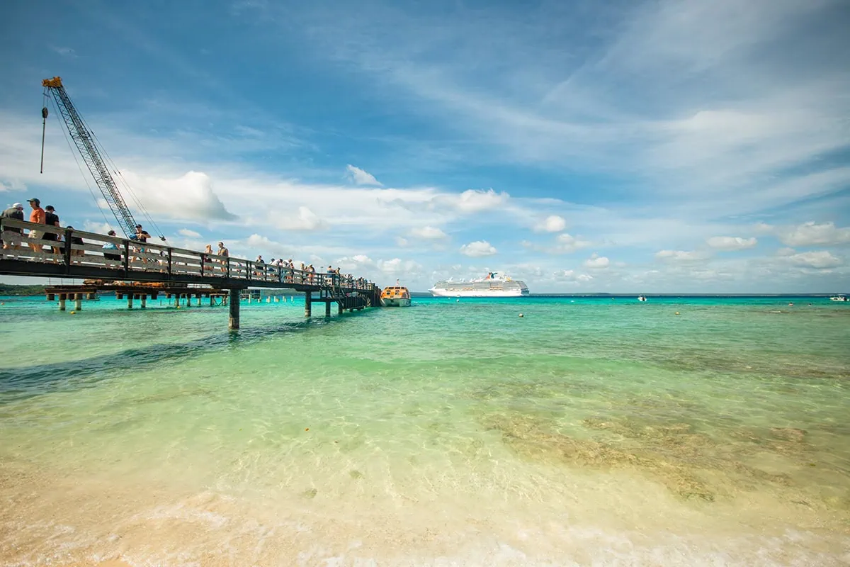 cruise passengers arriving off their tender boats onto the wooden pier in Lifou.
